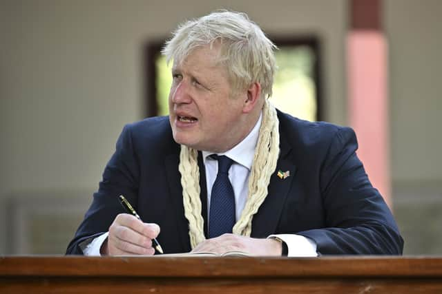 Conservative MPs will be given a free vote to decide on whether the Prime Minister should face an inquiry over misleading parliament. Pictured is Prime Minister Boris Johnson writing in the visitors' book during his visit to Mahatma Gandhi's Sabarmati Ashram in Ahmedabad, as part of his two day trip to India. Picture date: Thursday April 21, 2022. Picture: Ben Stansall/PA Wire