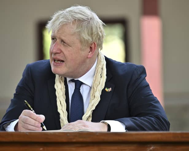 Conservative MPs will be given a free vote to decide on whether the Prime Minister should face an inquiry over misleading parliament. Pictured is Prime Minister Boris Johnson writing in the visitors' book during his visit to Mahatma Gandhi's Sabarmati Ashram in Ahmedabad, as part of his two day trip to India. Picture date: Thursday April 21, 2022. Picture: Ben Stansall/PA Wire