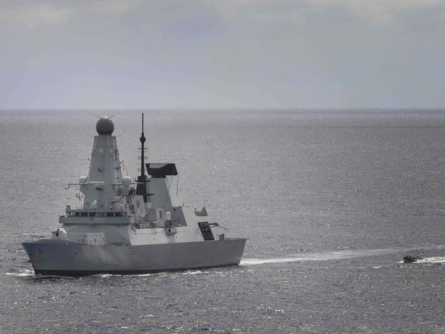 HMS Dauntless prepares to recover her sea boat during a narcotics bust in the Eastern Caribbean.
