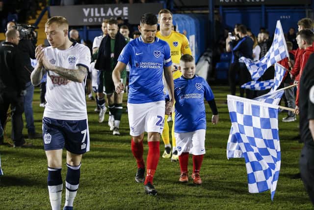 Gareth Evans, right, and Nicky Adams lead out the Pompey and Bury teams ahead of last season's Checkatrade Trophy semi-final at Gigg Lane.  Picture:  Daniel Chesterton