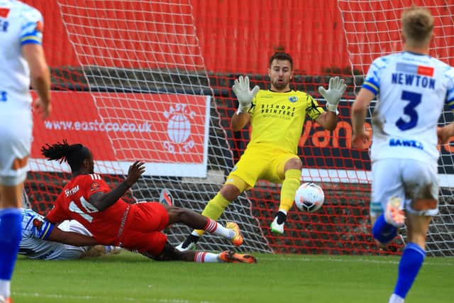 Ade Azeez puts Welling ahead, firing past Ross Worner. Picture by Dave Haines.
