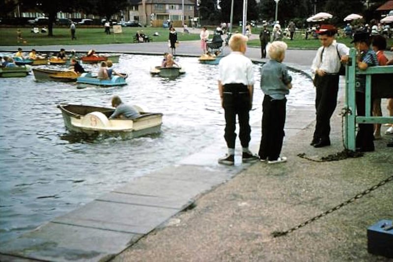 Boats galore on Canoe Lake, Southsea 1960. Two lads in cowboys hats.