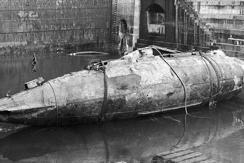 The Royal Navy's first submarine, the Holland I, in a basin at Devonport dockyard after being salvaged, 8th December 1982. The Holland I sank while on tow to the breaker's yard and lay on the sea bed near the Eddystone lighthouse for sixty-nine years. The vessel is due to be restored and displayed at the Royal Navy Submarine Museum at Gosport.
(Photo by Keystone/Hulton Archive/Getty Images)