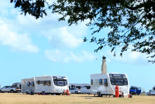 Travellers on Southsea Common, Royal Navy memorial, behind.