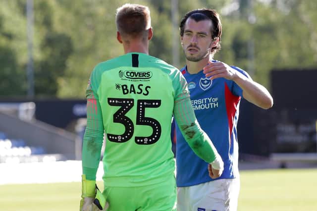 John Marquis consoles Alex Bass after Pompey's League One play-off loss. Picture: Robin Jones/Getty Images