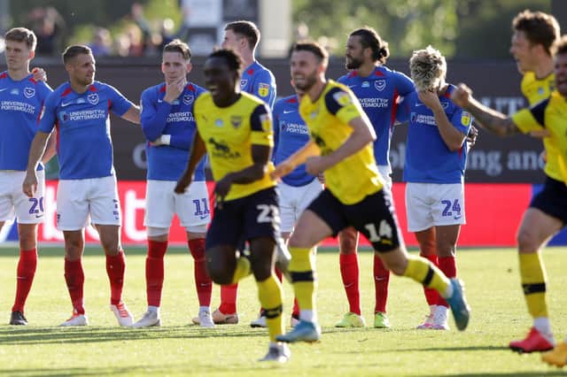 Pompey's players enviously look on as Oxford celebrate play-off victory at the Kassam Stadium.  Picture: Robin Jones/Getty Images