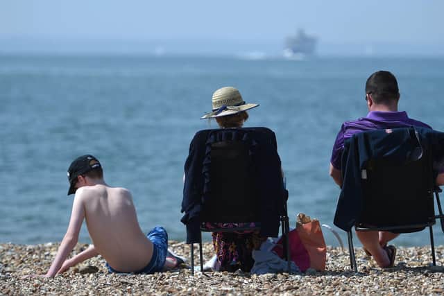 Sunbathers enjoy the warm weather on beach. Picture: Andrew Matthews/PA Wire