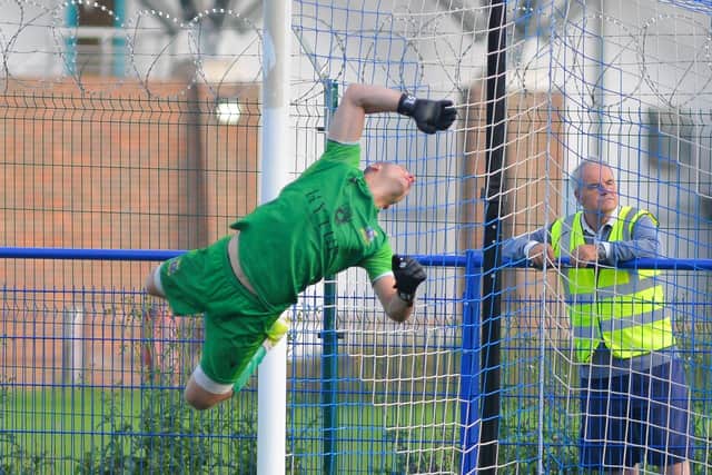 Baffins keeper Konrad Szymaniak in mid-air action during the shock FA Vase loss to Andover Town. Picture: Martyn White