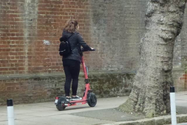 A Voi scooter being ridden on the pavement on Ordnance Road, Portsea in May 2022