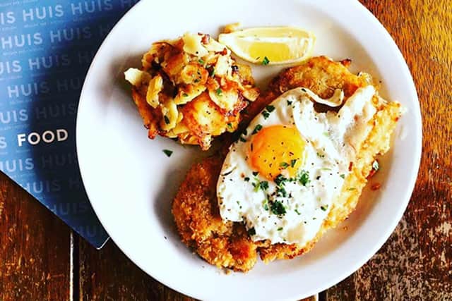 Huis's Wienerschnitzel - Vienna style pork schnitzel HUIS Pilsner breaded, topped with a free range fried egg, served with bacon and onion fried potatoes.