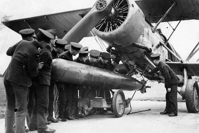 February 1937:  A torpedo being attached to a 'Fairey Swordfish' plane at the RAF Station at Gosport.  (Photo by Keystone/Getty Images)