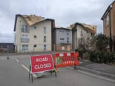 The road outside the block of flats has been cordoned off due to the damage. Picture: Emily Turner