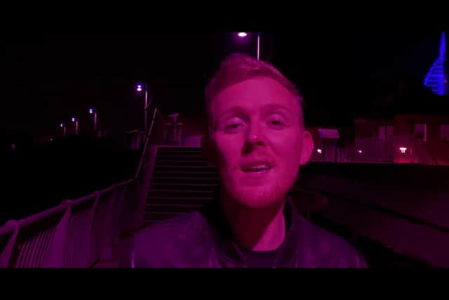 Aled Price, pictured in the music video for "You and I" walking along the Hot Walls with the Spinnaker Tower in the background.