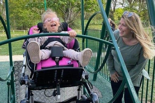 Alexandra Bufton with her daughter Doris on the new swing at Holly Hill park