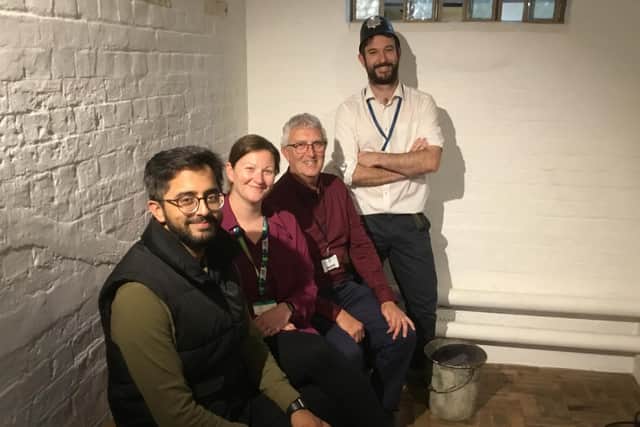 EHDC Cllr Adeel Shah, Community Development Officer Lucy Whittle, Jeremy Mitchell (Fundraising Trustee) and Ryan Watts (Head of Engagement) in the former Petersfield police station's prison cell