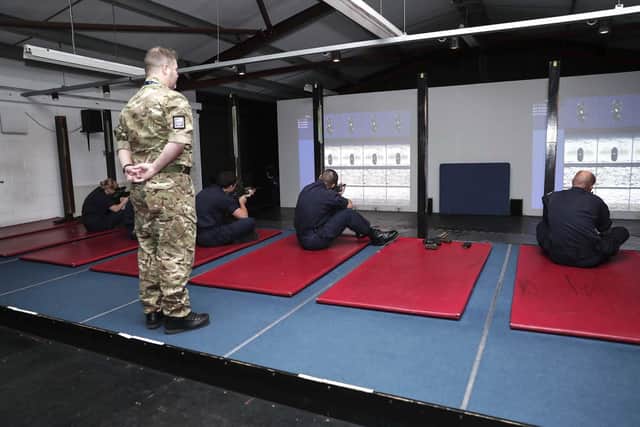 Trainees takes aim at the digital rifle range on HMS Excellent. Photo: Royal Navy