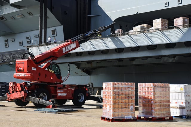 Pictured: Thousands of tins of baked beans being loaded onto the ship.