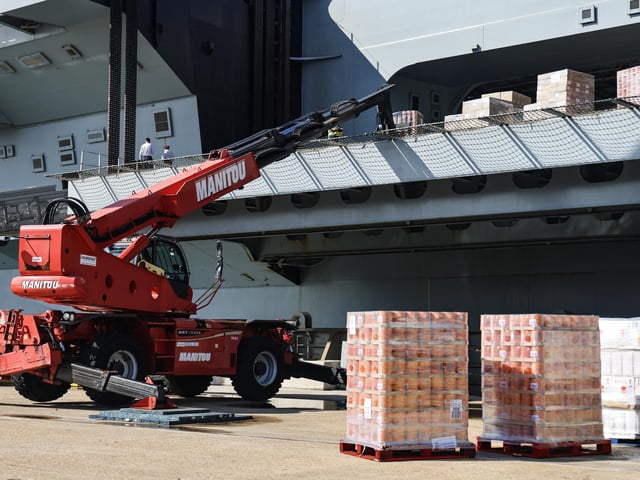 Pictured: Thousands of tins of baked beans being loaded onto the ship.