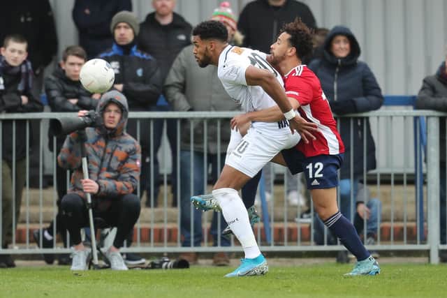Jonah Ayunga tussles with Hampton's Sam Cox. Photo by Dave Haines