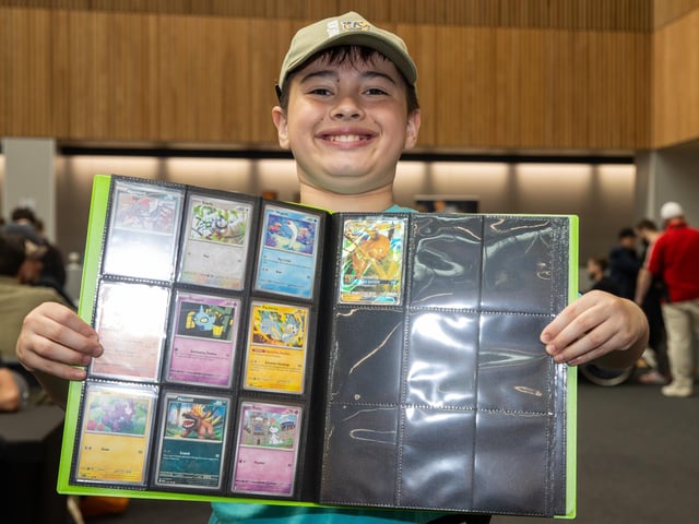 Issac, 9, from Portsmouth, proudly displays his Pokemon cards.  Photos by Alex Shute