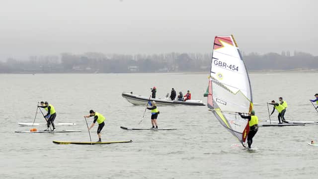 Paddleboarders and windsurfers off Hayling Island seafront. Picture by Malcolm Wells