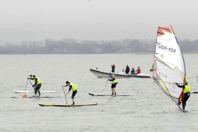Paddleboarders and windsurfers off Hayling Island seafront. Picture by Malcolm Wells