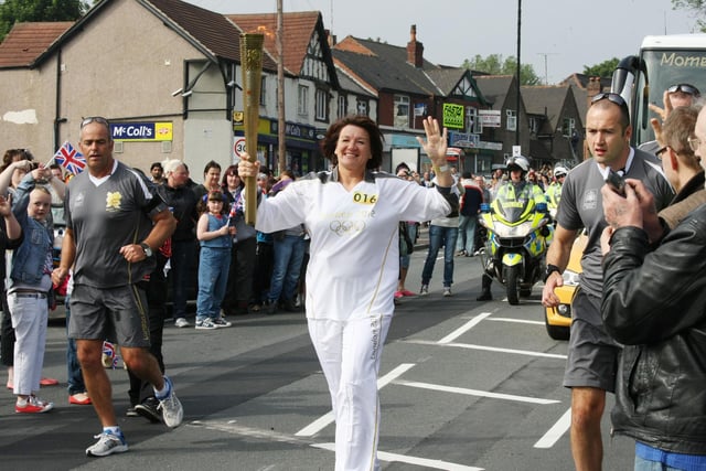 Olympic Torch Relay in Rotherham. Tracy Haycox from Safe@Last running down Doncaster Road on her leg