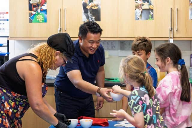 Alan Mak MP helps children preparing a healthy lunch at a HAF summer holiday club at Mengham Infant School on Hayling Island