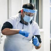 Swab samples being taken at a coronavirus test and trace centre. Photo: Danny Lawson/PA Wire