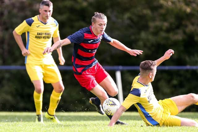 Zak Willett in action for Paulsgrove (red/blue), who have only played 10 Hampshire Premier League Senior Division games this season - fewer than anyone else in the top flight. Picture: Chris Moorhouse