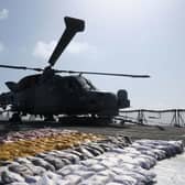 The Wildcat helicopter stands guard over the drugs haul on the frigate's flight deck. Picture: Lt Cdr Jason Jones/Royal Navy.