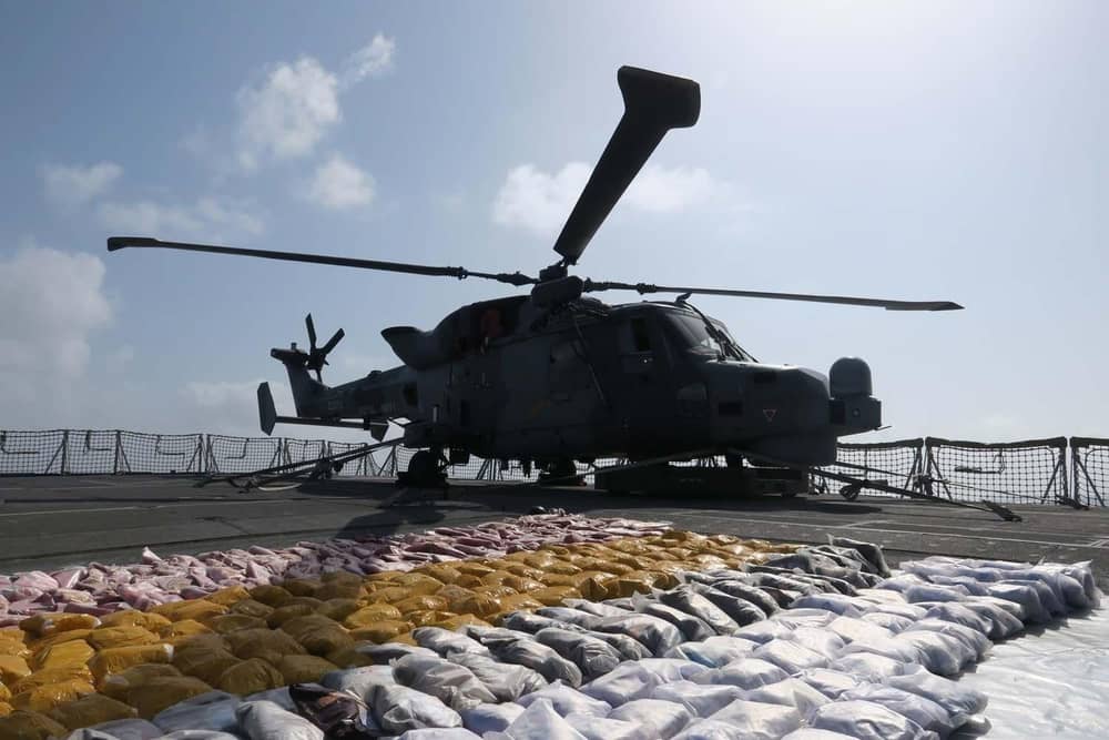 The Wildcat helicopter stands guard over the drugs haul on the frigate's flight deck. Picture: Lt Cdr Jason Jones/Royal Navy.
