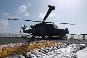 The Wildcat helicopter stands guard over the drugs haul on the frigate's flight deck. Picture: Lt Cdr Jason Jones/Royal Navy.
