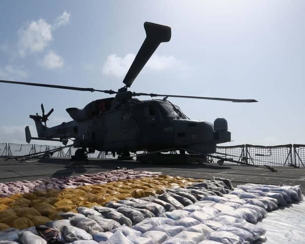 The Wildcat helicopter stands guard over the drugs haul on the frigate's flight deck. Picture: Lt Cdr Jason Jones/Royal Navy.