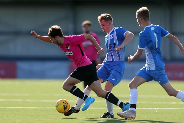 AFC Trades' Adam Puckett, left, in action against Sheperd's Crook. Picture: Chris Moorhouse