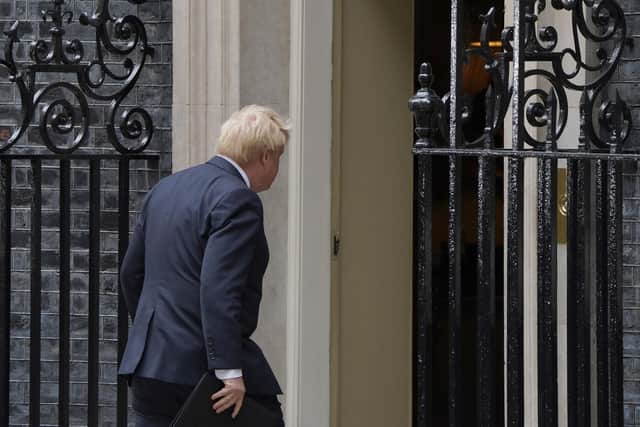 Prime Minister Boris Johnson walks into 10 Downing Street, London, after reading a statement formally resigning as Conservative Party leader after ministers and MPs made clear his position was untenable.