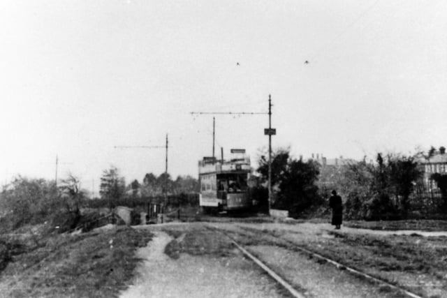 Crossing Southwick Hill Road bridge With the Queen Alexandra Hospital peeking over the hedgerow  we see a tram passing over Southwick Hill Road. Picture: Barry Cox postcard collection