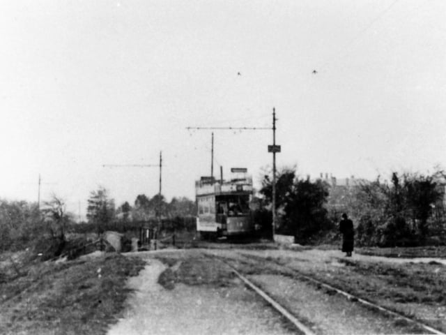 Crossing Southwick Hill Road bridge With the Queen Alexandra Hospital peeking over the hedgerow  we see a tram passing over Southwick Hill Road. Picture: Barry Cox postcard collection