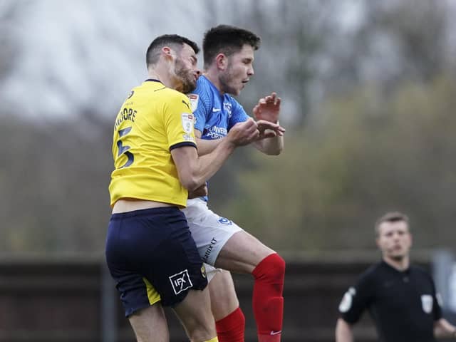 George Hirst was shown a yellow card for his challenge on Elliott Moore.   Picture: Jason Brown