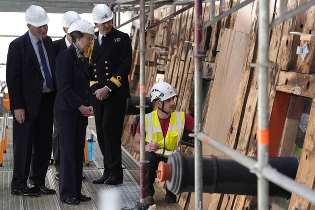 The Princess Royal (2nd left) speaks to a shipwright during a visit to see the HMS Victory Conservation Project at the National Museum of the Royal Navy in Portsmouth Historic Dockyard.