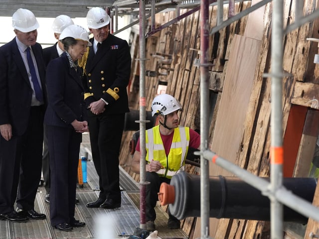 The Princess Royal (2nd left) speaks to a shipwright during a visit to see the HMS Victory Conservation Project at the National Museum of the Royal Navy in Portsmouth Historic Dockyard.