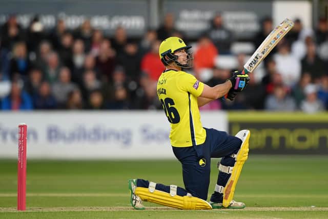 Hampshire's James Fuller hits a six, leading to a smashed window at The Cloud County Ground in Chelmsford. Photo by Alex Davidson/Getty Images.