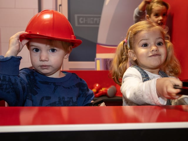 Cooper and Rio, both 2, enjoy the new fire station at Mini Town Role Play & Cafe. Photos by Alex Shute