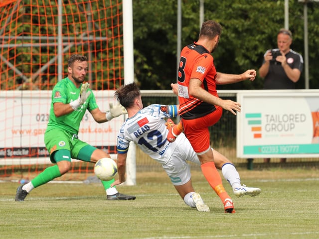 Brett Pitman about to level for Portchester despite a challenge from Benny Read. Picture by Dave Haines
