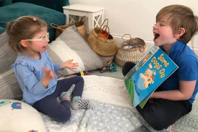 Ivy reading with her brother Oliver