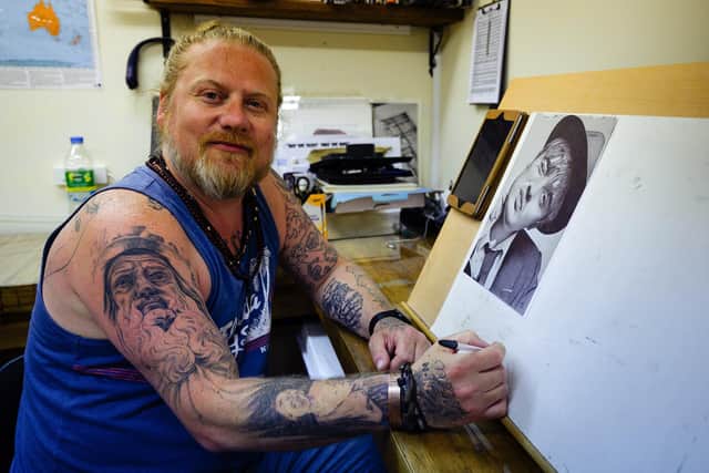 Dan Williams at easel were creates his unique artworks. He said he's happy to have his Facebook account back after being hacked. Picture: Keith Woodland (170621-3).
