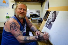 Dan Williams at easel were creates his unique artworks. He said he's happy to have his Facebook account back after being hacked. Picture: Keith Woodland (170621-3).