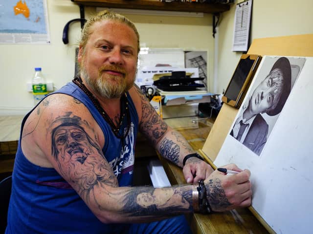 Dan Williams at easel were creates his unique artworks. He said he's happy to have his Facebook account back after being hacked. Picture: Keith Woodland (170621-3).