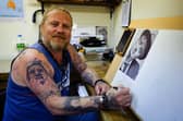Dan Williams at easel were creates his unique artworks. He said he's happy to have his Facebook account back after being hacked. Picture: Keith Woodland (170621-3).