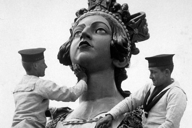 5th April 1934:  Sailors from the naval training college at Gosport, giving a statue of HM Queen Victoria a soap and water wash.  (Photo by Reg Speller/Fox Photos/Getty Images)